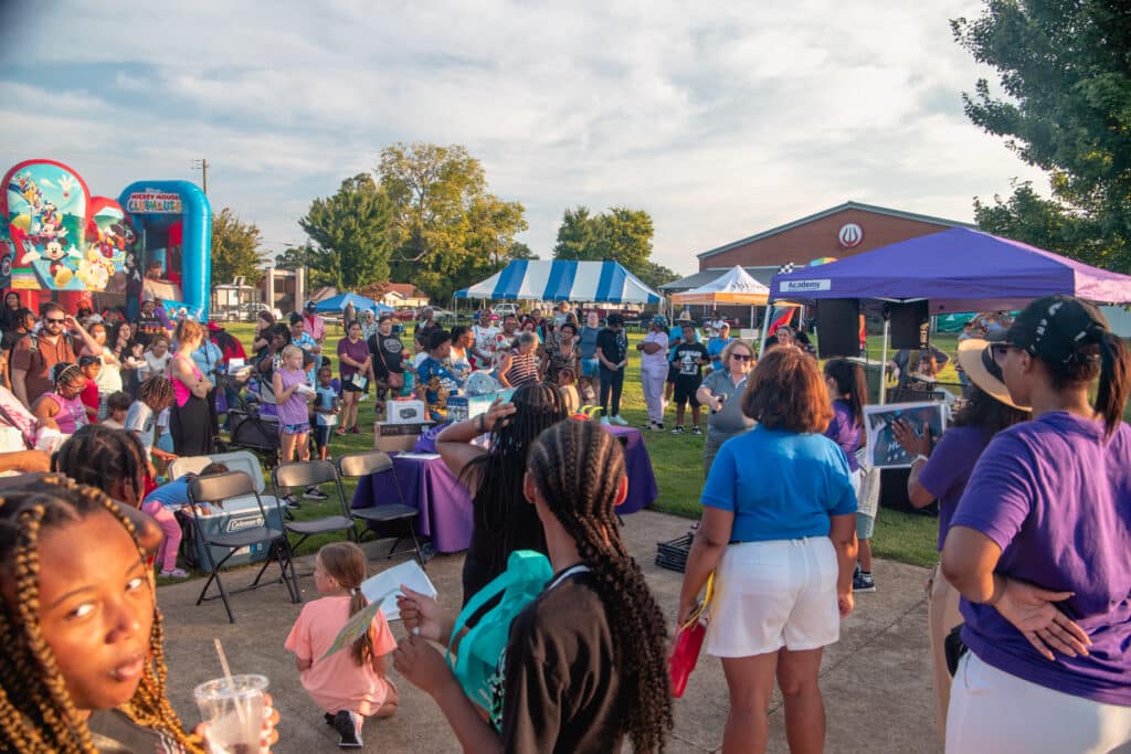 A large crow is gathered at the Community Fun & Wellness Block Party.